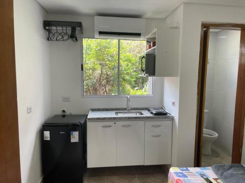 a small kitchen with a sink and a window at Condomínio Residencial Vitória 3 in Sao Paulo