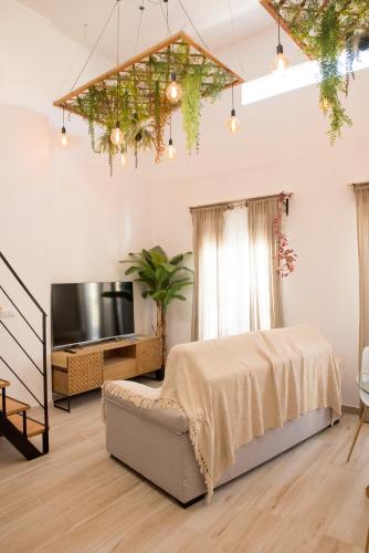 a bedroom with a bed and a tv in a room at Agua Viva Deluxe in Málaga