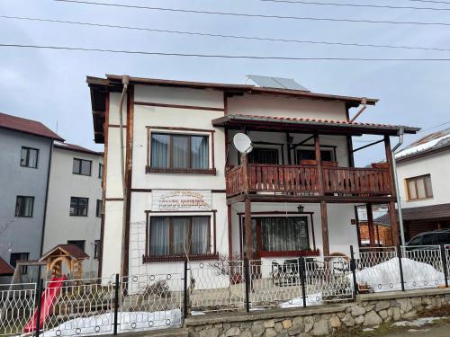 a house with a balcony on top of it at Mama Emiliya Guest House in Beli Iskar
