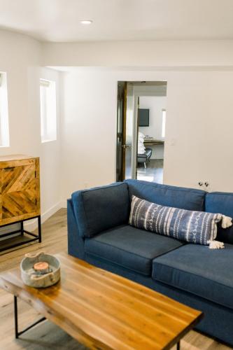 a blue couch in a living room with a table at Werner Lake Front in Bass Lake