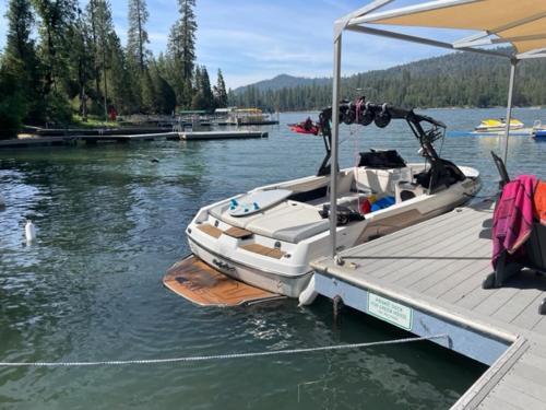 a boat is docked at a dock in the water at Werner Lake Front in Bass Lake