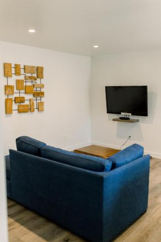 a blue couch in a room with a flat screen tv at Werner Lake Front in Bass Lake