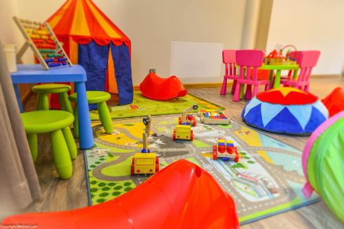 a childs play room with toys and tables and chairs at Hotel Biathlon Sport & Spa in Szklarska Poręba