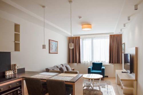 a living room with a couch and a table at Apartmani Zepterme by CENTRAL in Vrnjačka Banja