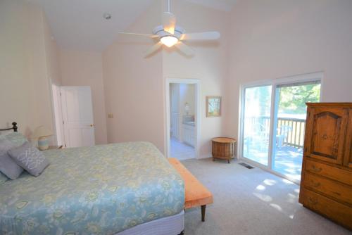 a bedroom with a bed and a ceiling fan at Brummett Lodge in Bass Lake