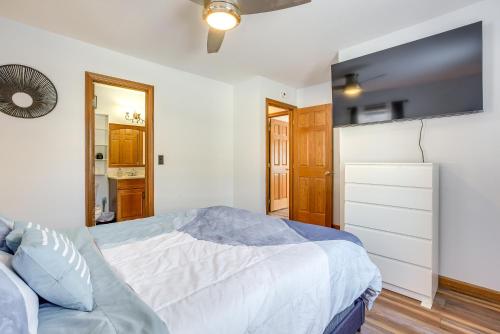 a bedroom with a bed and a tv on the wall at Hocking Hills Hideaway Near Lake Logan in Logan