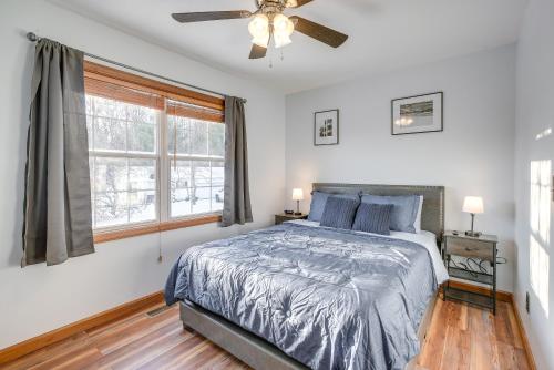 a bedroom with a bed and a ceiling fan at Hocking Hills Hideaway Near Lake Logan in Logan