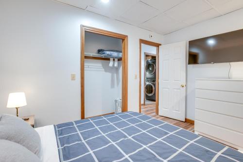 a bedroom with a bed and a washing machine at Hocking Hills Hideaway Near Lake Logan in Logan