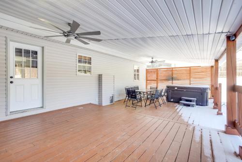 a living room with a ceiling fan and a table and chairs at Hocking Hills Hideaway Near Lake Logan in Logan
