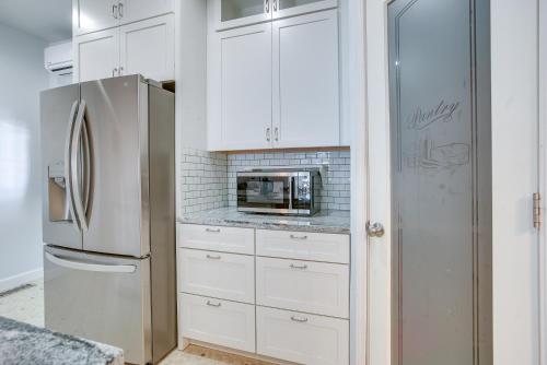 a kitchen with white cabinets and a refrigerator at 4 Mi to Lake Logan Hocking Hills Apartment in Logan