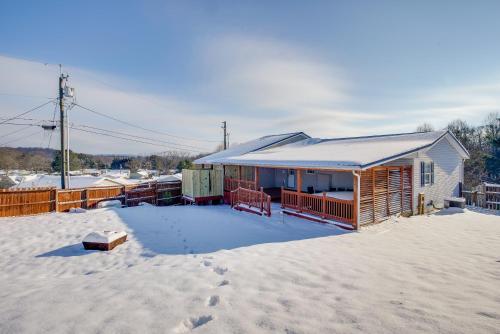 a house with a snow covered roof in the snow at 4 Mi to Lake Logan Hocking Hills Apartment in Logan