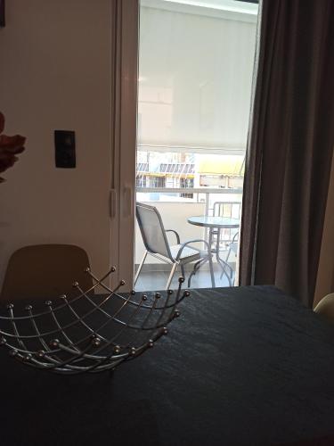 a hammock in a room with a table and chairs at Sodi Cozy apartment in Kardítsa