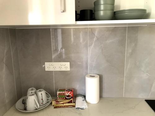 a kitchen with a counter top with a sink and towels at New stand-alone 2-bedroom house in Baulkham Hills