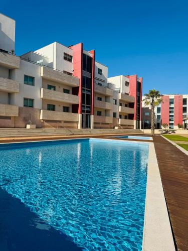 a swimming pool in front of a building at Costa Nova Premium Apartment & Pool in Costa Nova