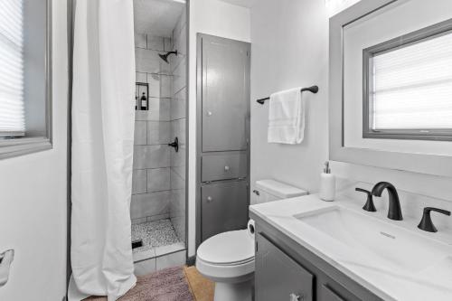 a bathroom with a toilet and a sink and a shower at 3 Bedroom Family Home in Lake Charles La in Lake Charles