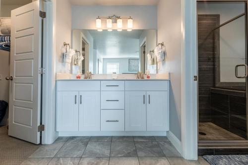 a white bathroom with a sink and a shower at Beautiful Sun Villa at The Casitas Sienna Hills in Washington