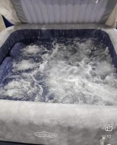 a pool of water in a container with snow at Apartmán Dáša in Frymburk