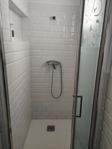 a bathroom with a shower with a glass door at ALOJAMIENTOS DG in Punta Umbría