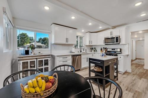 a kitchen with a table with a basket of fruit on it at Remodeled West Sacramento home in quiet location! in West Sacramento