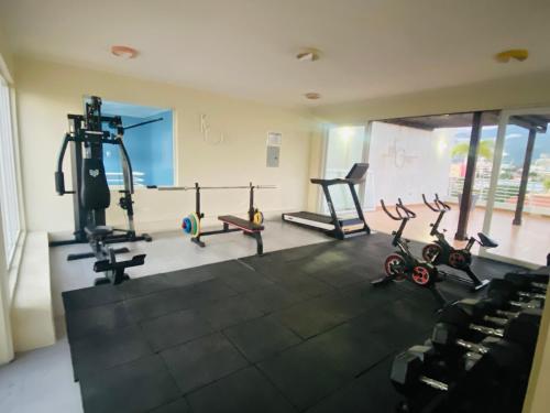 a gym with several treadmills and machines in a room at Metcalfe Two Bedroom Suite in Kingston