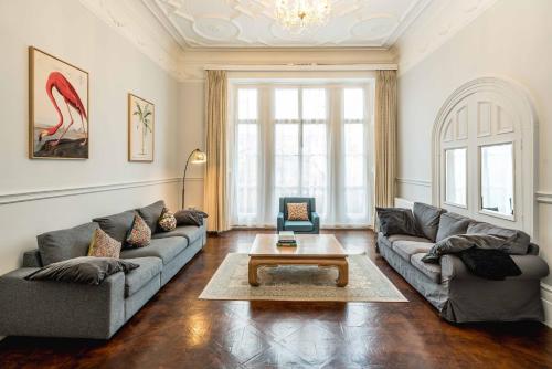 a living room with two couches and a coffee table at SouthKen Palace Suites in London