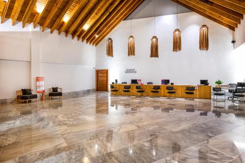 a lobby with desks and chairs in a building at Viva Miches by Wyndham, a Trademark All Inclusive Resort in Miches