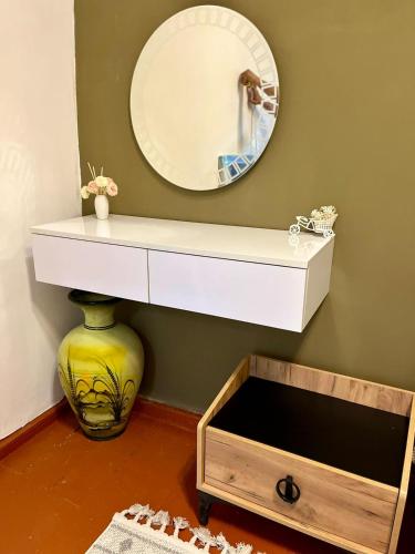 a bathroom with a mirror and a white sink at Holiday Home in Baku