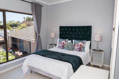 a bedroom with a large bed and a large window at Grandview Guesthouse in Cape Town