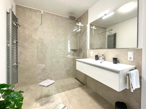 a bathroom with a white sink and a mirror at Senne Bungalow in Augustdorf