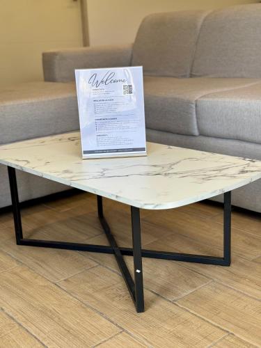 a coffee table with a sign on top of it at Villas Na-tiva Guanacaste in Plazuela