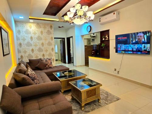 a living room with a couch and a tv at Opulent 5-BHK Entire House in Bahria Town Phase 3 in Rawalpindi