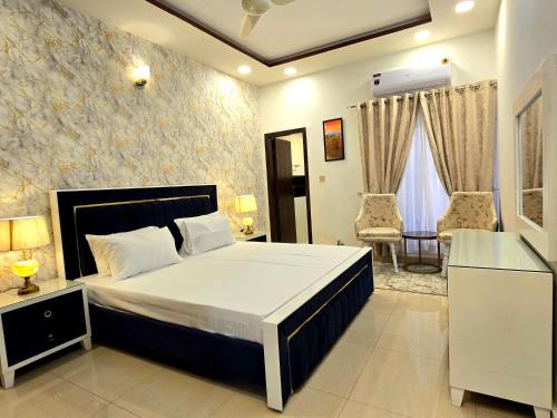 a bedroom with a bed and a table and chairs at Opulent 5-BHK Entire House in Bahria Town Phase 3 in Rawalpindi