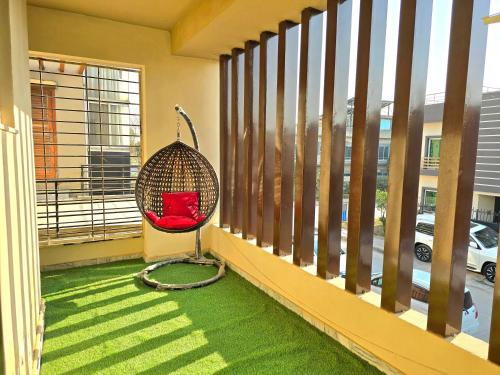 a red chair sitting on a balcony at Opulent 5-BHK Entire House in Bahria Town Phase 3 in Rawalpindi