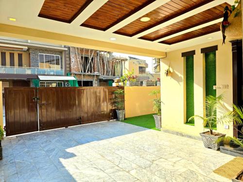 a patio with a fence and a wooden gate at Opulent 5-BHK Entire House in Bahria Town Phase 3 in Rawalpindi