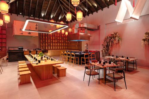 a restaurant with tables and chairs in a room at Viva Miches by Wyndham, a Trademark All Inclusive Resort in Miches