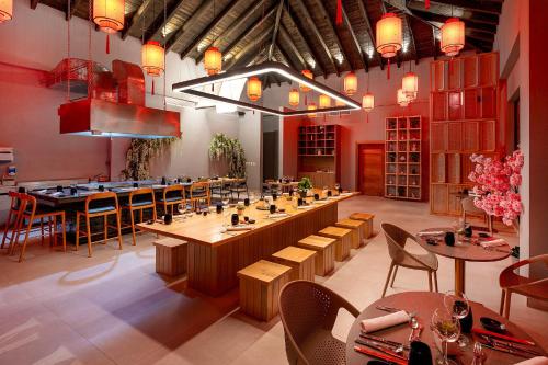 a restaurant with a bar with tables and chairs at Viva Miches by Wyndham, a Trademark All Inclusive Resort in Miches