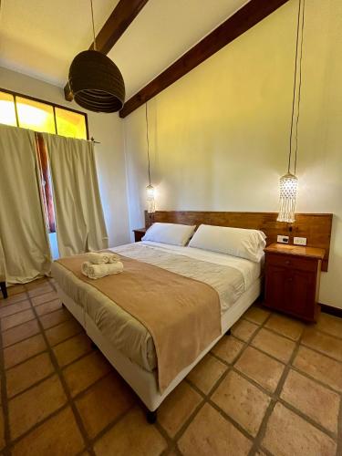 a bedroom with a large bed in a room at Hotel Plaza Cafayate in Cafayate