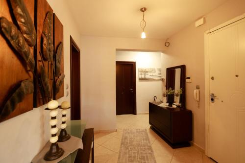 a hallway with a bathroom with a sink and a mirror at Βίλα Ιωάννα 3 in Mesimérion