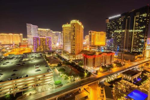 a view of a city at night with buildings at No Resort Fee Strip View Balcony+ Free Valet+ Pool in Las Vegas