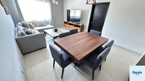 a living room with a wooden table and chairs at Departamentos en el centro de Mazatlán in Mazatlán