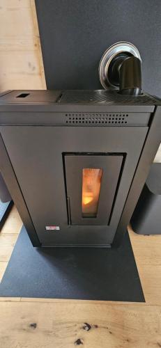a stove with a fire inside of it at Tiny House im Grünen in Sankt Margrethen