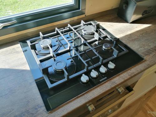 a stove top oven sitting on top of a counter at Tiny House im Grünen in Sankt Margrethen