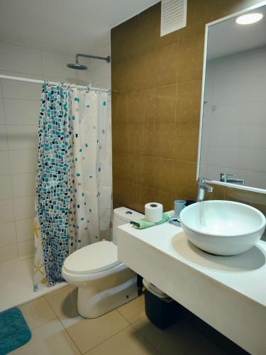 a bathroom with a sink and a toilet and a shower at Depa Bonito en Condominio ! in Tacna