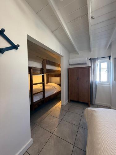 a bedroom with two bunk beds and a window at CASA PLAYA - Beachfront Paradise sandy beach in Ensenada