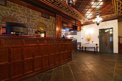 a bar in a restaurant with a stone wall at Hotel Petrotechno in Tsepelovo