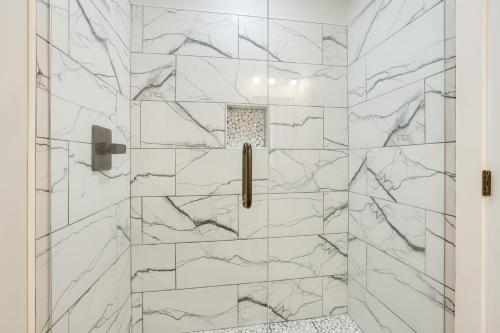 a bathroom with a shower with marble tiles at 7 Mi to Talladega Superspeedway Home with Lake View in Lincoln