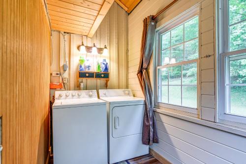 a laundry room with a washer and dryer next to a window at Historic Sapphire Cabin with Porch, Updated Interior in Sapphire