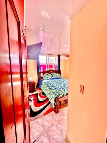 a small bedroom with a bed in a room at Posada Seven Colours Ocean in Providencia