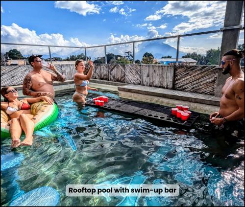 a group of people sitting in a swimming pool at Dreamboat Hostel in Panajachel