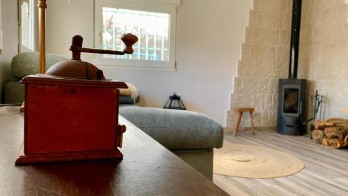 a living room with a wood stove and a couch at Paraje Sanchazurra in Vallejera de Riofrío